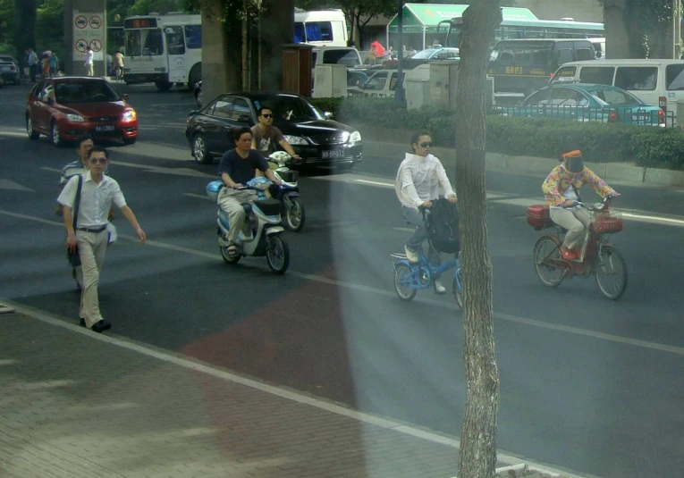 a group of people on bicycles are going down the street