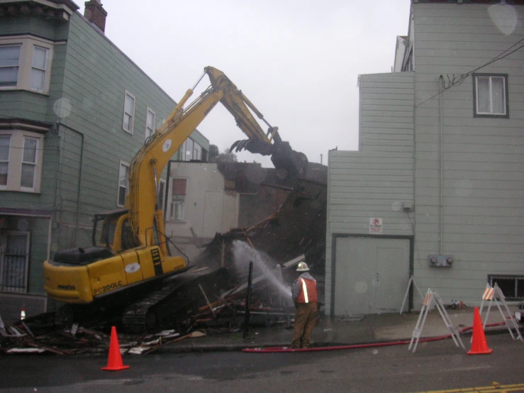 the construction crew looks at the wreckage of a fire truck