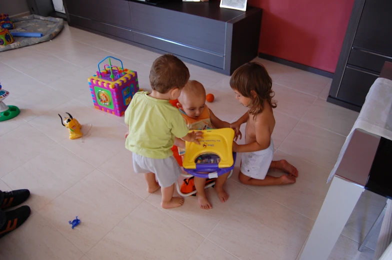 three children play with each other in the living room