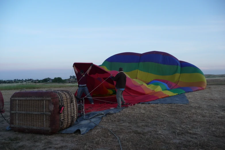people are standing around a large  air balloon