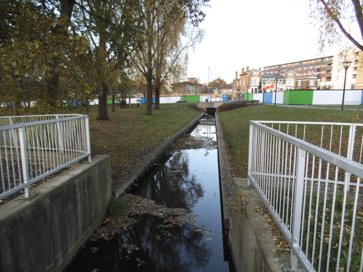 a small channel of water running through a park