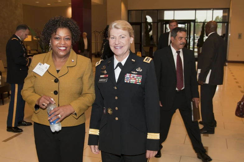 two women in military uniforms standing together