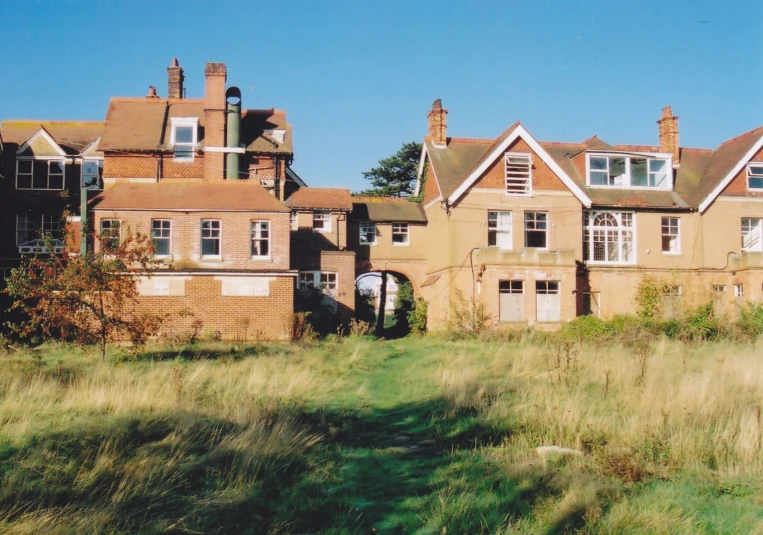 a brick building has windows above the doors and a small door with a key hole in the front