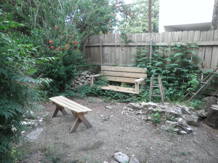 a wooden bench sitting in the middle of a garden