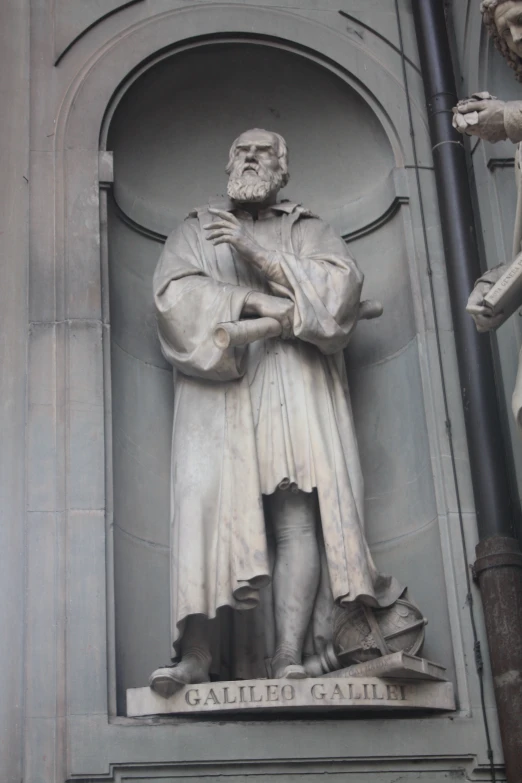 an artistic picture of a statue of a man standing next to a building