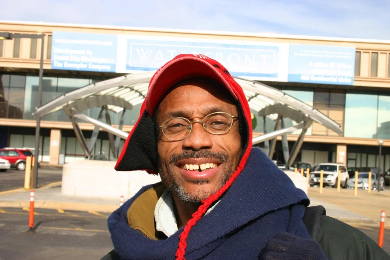 man wearing hoodie and glasses at airport terminal