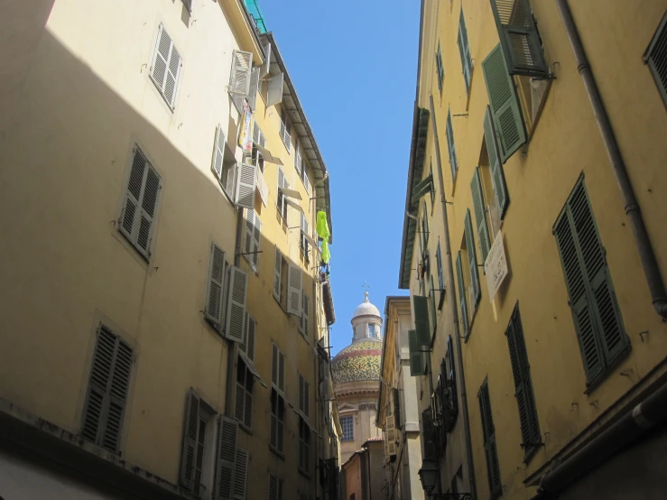 view down an alleyway of some buildings