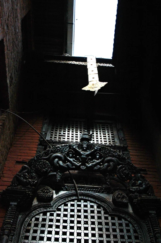 an up view looking down into a building through the window