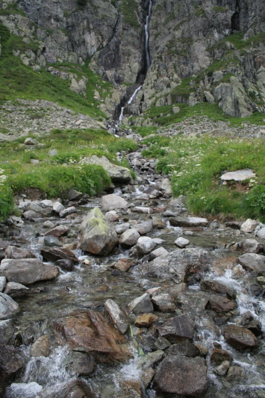 several large rocks are sitting along a wall