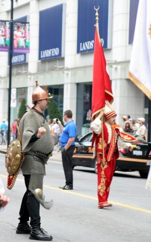 two men in full armor walking down the street