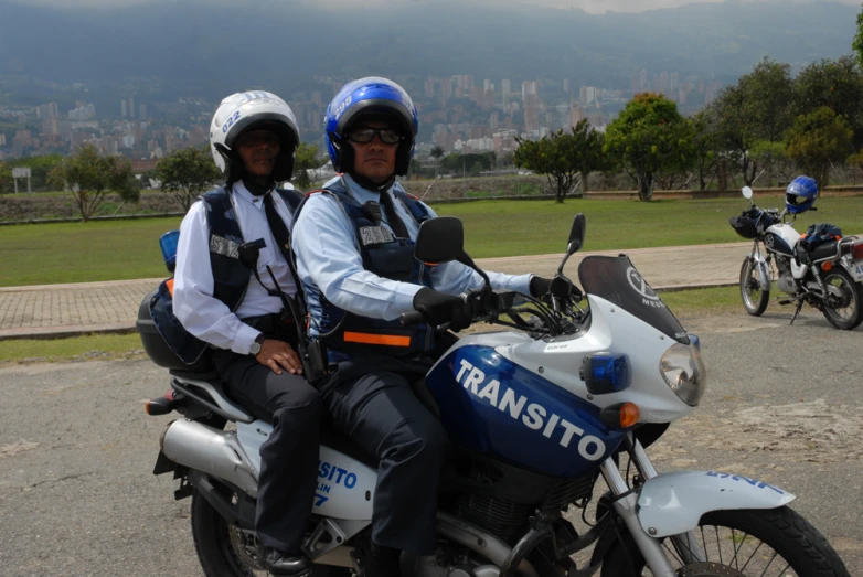 two police officers are sitting on a motorcycle