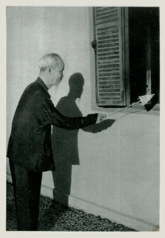 a man with his shadow casting on a wall