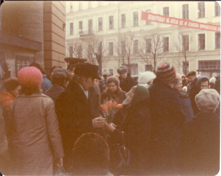 several people are gathered together in the street