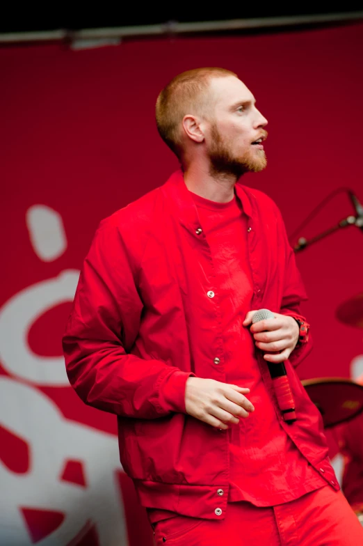 a man wearing red with a microphone standing next to him