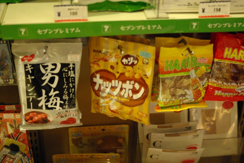 a shelf in a store filled with packets of food