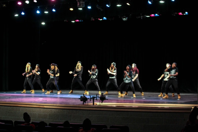 a dance performed on a stage with lights