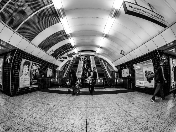 people standing on escalator in a subway station