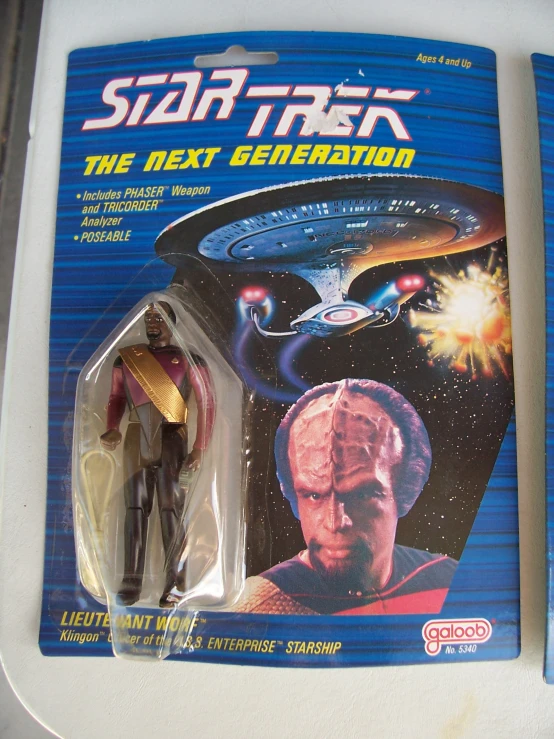 a toy with a star trek figure next to a box