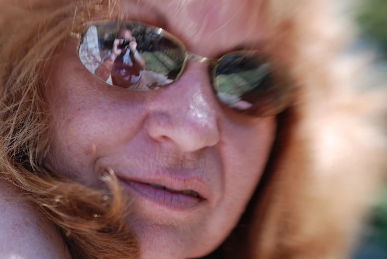 a woman in a fur coat, sun glasses and some flowers