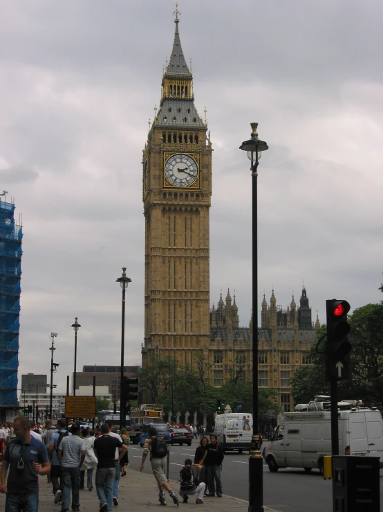 a crowded city street has big ben in the background