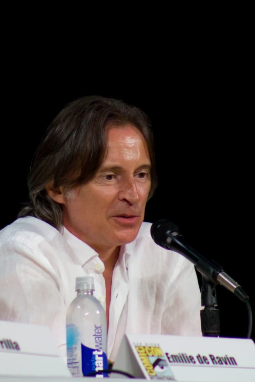 a man sitting at a table and talking