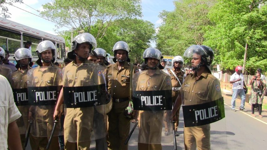 several uniformed men in uniform standing together outside