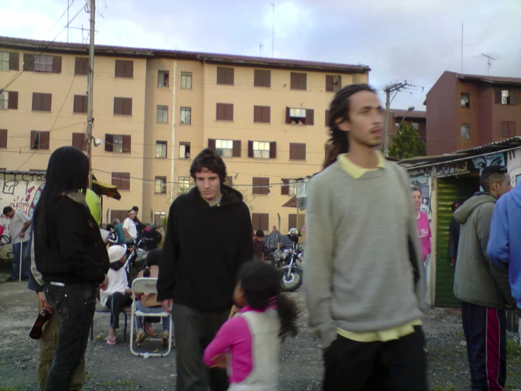 a group of people outside with tents in the background