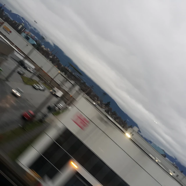 a city view through a windshield in the rain