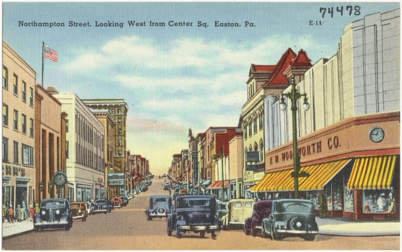 old pograph of busy town with tall buildings