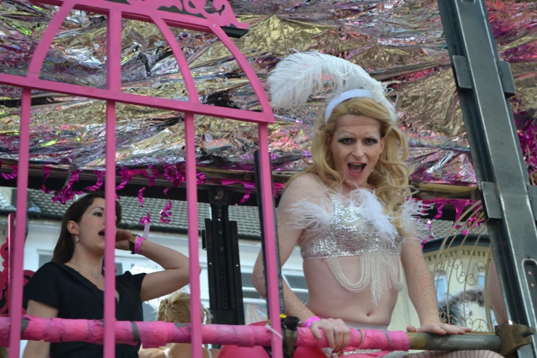 a woman wearing white with a very unique dress in a pink float