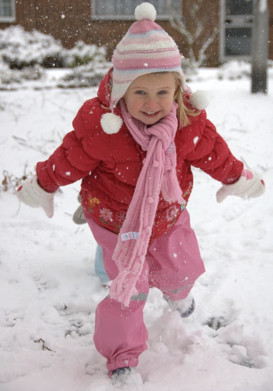 the small child is walking through the snow