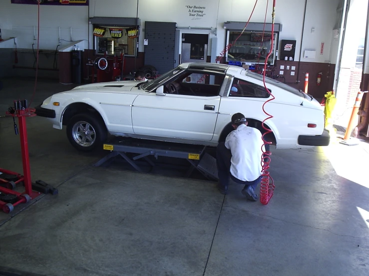 the car is being serviced by a service guy