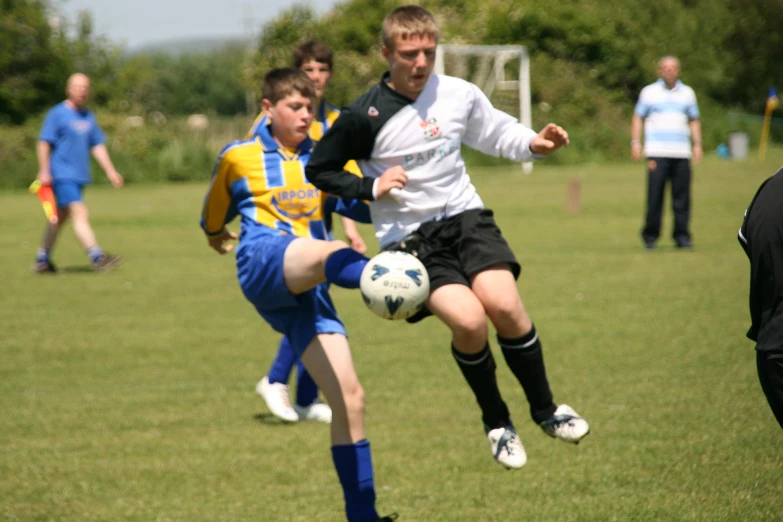 a couple of men kicking around a soccer ball