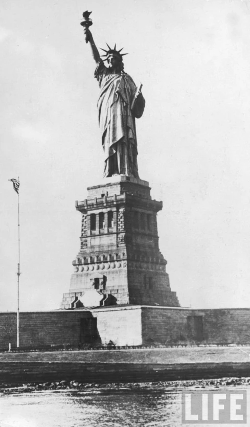the statue of liberty stands near the entrance to the harbor