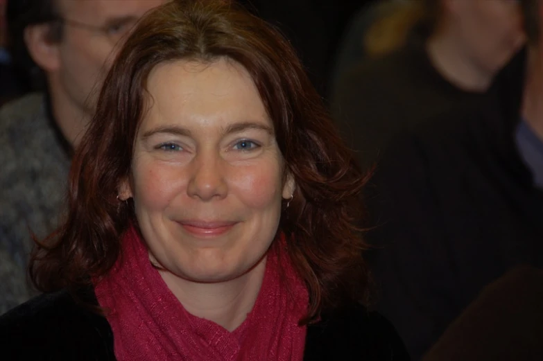 a woman in red scarf sitting next to others