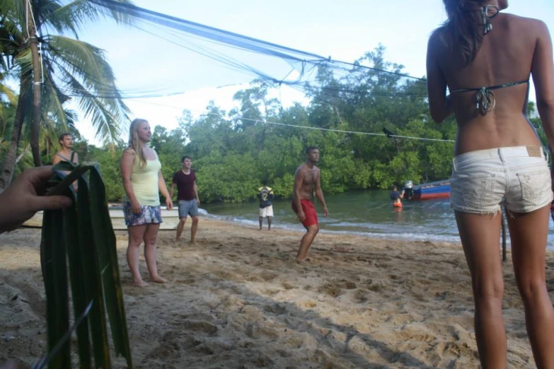 some people walking around in their bathing suits on the beach