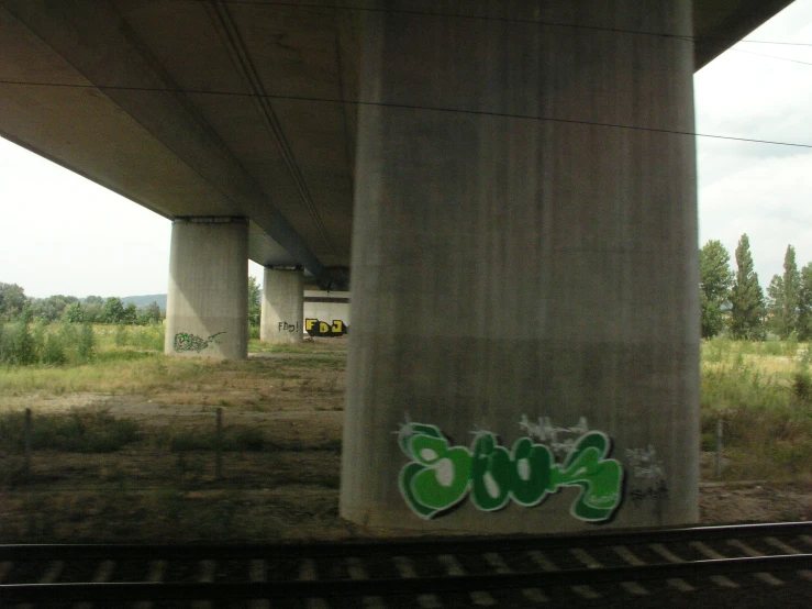 an abandoned highway bridge over a grassy field