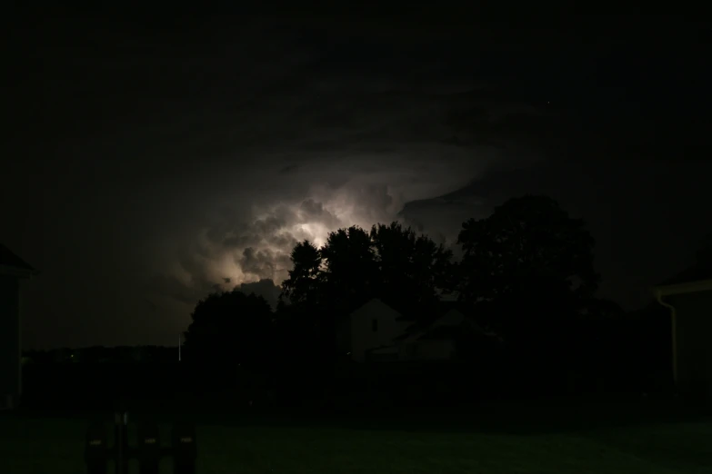 a picture taken of the storm approaching through a field at night