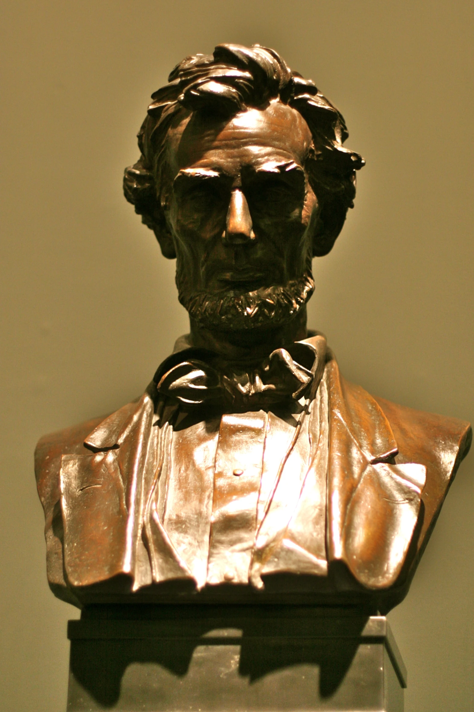 a bronze statue of lincoln in a room