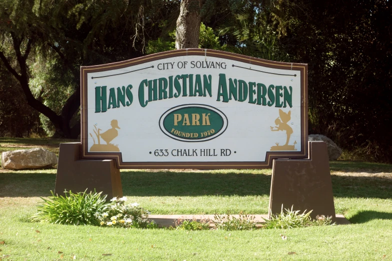 a large sign advertising an event in a park