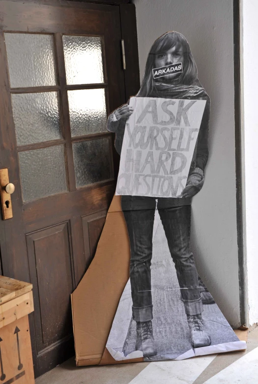 a cardboard cutout of the life and work of neil molen, with a sign in front