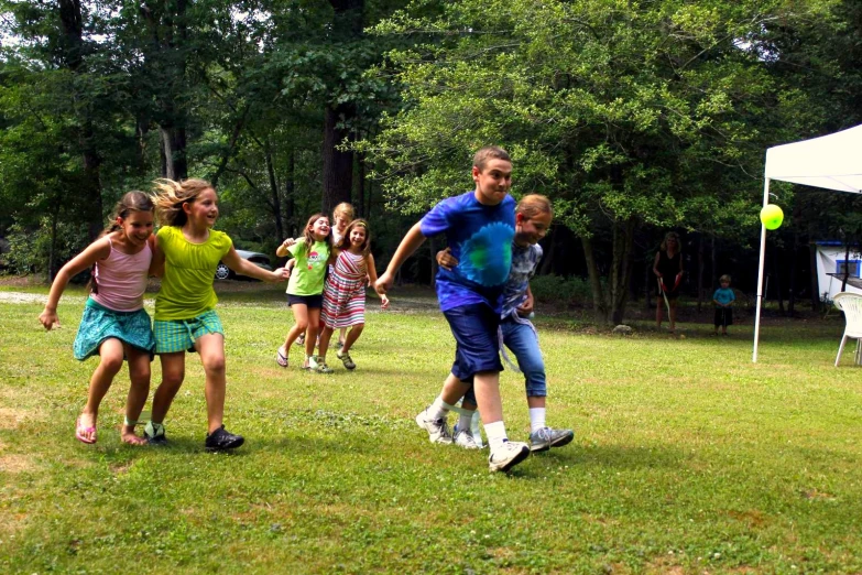 a couple of s are playing frisbee in a park