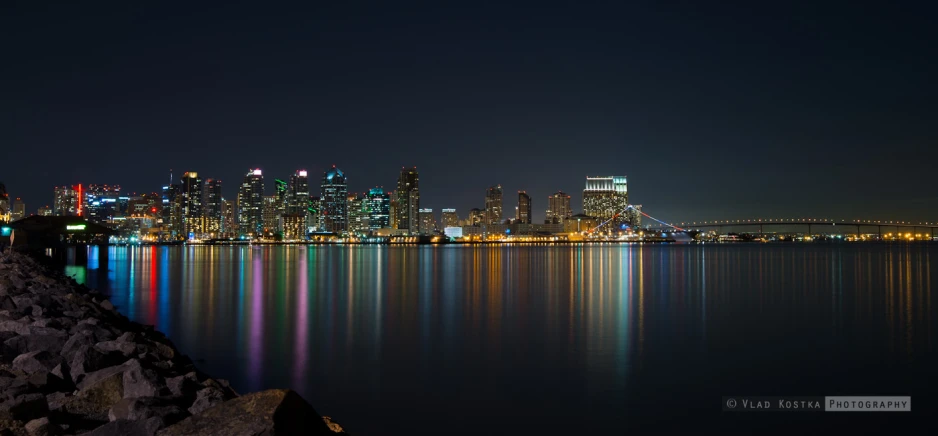 a body of water with buildings in the distance