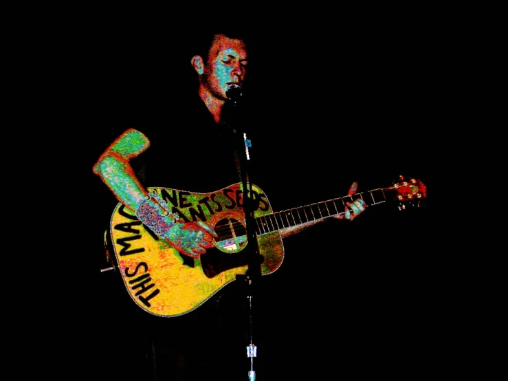 a man holding a guitar on a stage