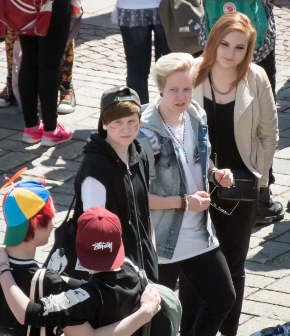 people standing on a brick road next to a group of s