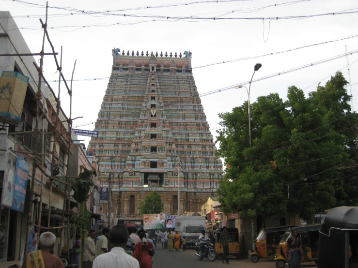 large tower of hindu temple near some other structures