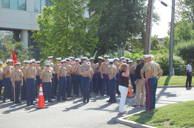 some men and women in uniform marching on a street