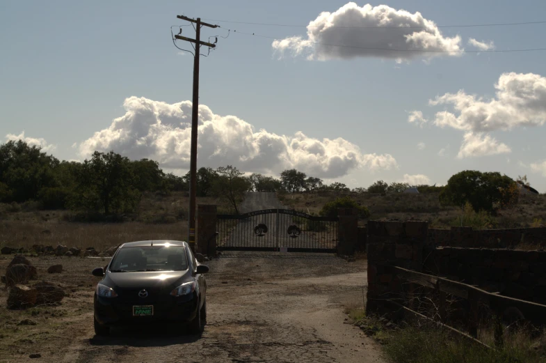 a vehicle is parked on the dirt road