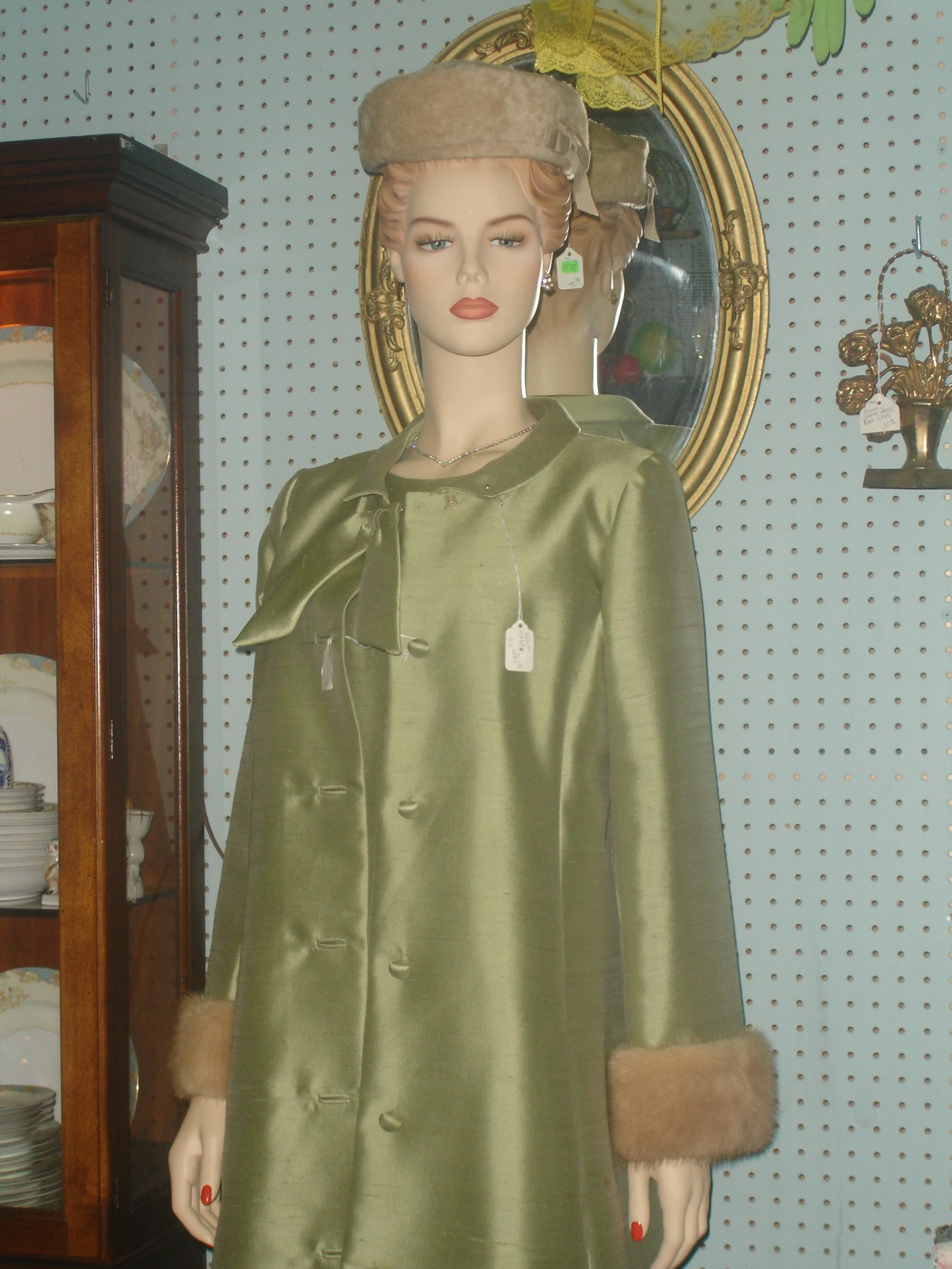 a green evening dress with gold fur collar and cuffs