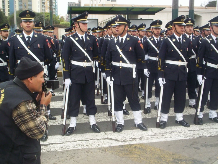 a man taking a picture of a line of soldiers